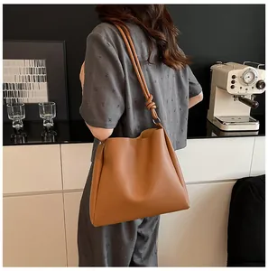 Retro large-capacity brown bucket tote bag featuring a unique knotted shoulder strap