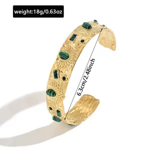 Detailed view of gold stainless steel cuff bracelet with green stones and 6.3cm size