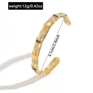 Gold stainless steel cuff bracelet with flower engravings and colorful stones detail