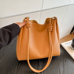 Vintage brown faux leather bucket bag featuring large capacity and knotted straps