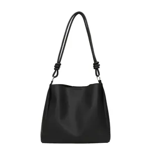 Minimalist black large capacity tote bag with unique knot shoulder strap detail