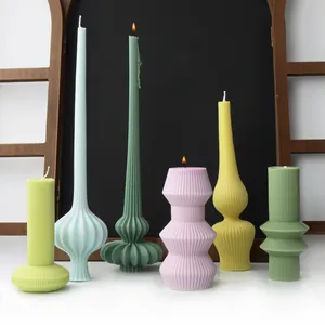 Artistic set of colorful ribbed sculptural candles in various geometric shapes