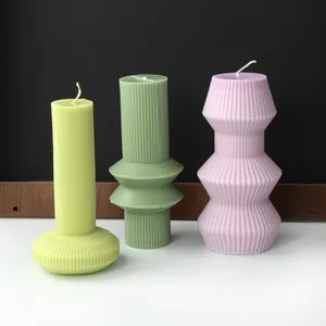 Close-up detail of ribbed geometric scented candles in colorful Nordic minimalist style