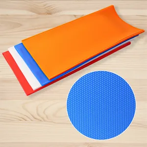 Detail showing the hexagonal honeycomb texture of colorful silicone foundation molds.