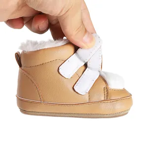 Detail view of winter baby bootie featuring plush lining and adjustable velcro straps.