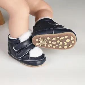 Detailed view of navy blue baby winter boots with non-slip sole and white fur lining