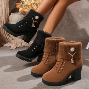 Detail of women's block heel boots with rhinestone knitted collar and pearls.