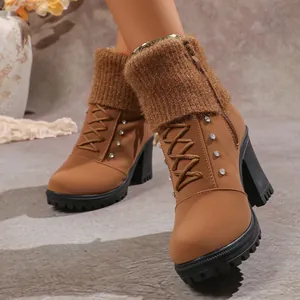 Detail of brown chunky high heel boots featuring rhinestone accents and knitted cuffs.