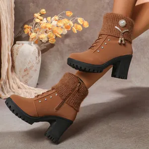 Close-up side view of camel chunky heel boots with knitted cuff and pearl brooch decoration