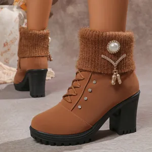 Close-up of brown high heel boots with a knit collar, pearls, and sparkling rhinestones.