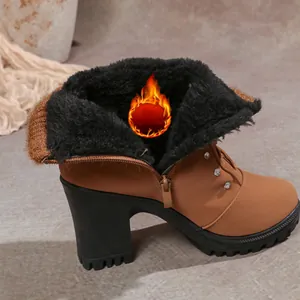 Detail view of brown chunky heel ankle boot with warm faux fur lining and side zipper