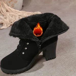 Detailed view of black chunky heel boots showing warm faux fur lining and side rhinestones.