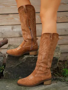 Classic brown suede embroidered western cowboy tall boots shown in an outdoor setting