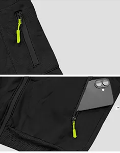 Detailed view showing functional zippered pockets on a black heavyweight fleece hoodie