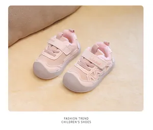 High-quality detailed view of pink fleece-lined toddler walking shoes on a soft cream mat