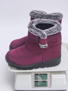 Macro view of purple waterproof snow boots showing the lightweight design on a scale.