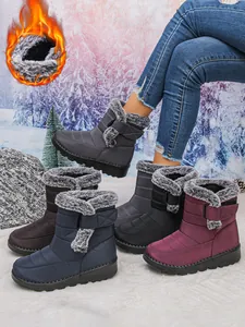 Close-up of waterproof women's snow boots with fur lining and velcro strap
