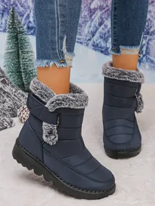 Warm navy blue waterproof snow boots with grey faux fur trim and Velcro closure for women.