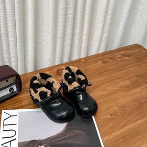 Détail de bottines en cuir pour bambins avec doublure chaude en polaire motif léopard