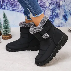 Detailed view of black waterproof snow boots with faux fur lining and velcro strap.
