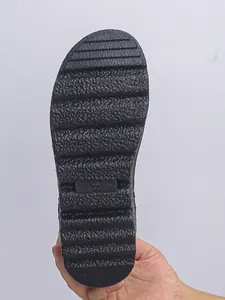 Detail view of the durable non-slip black textured rubber sole of the snow boots