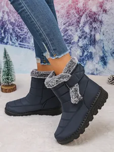 Detailed side view of women's navy blue waterproof snow boots with grey faux fur trim