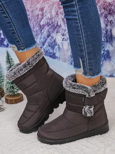 Detailed side view of warm brown women's snow boots with plush faux fur trim and Velcro strap