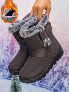 Detailed close-up of brown waterproof snow boots featuring warm plush faux fur lining.