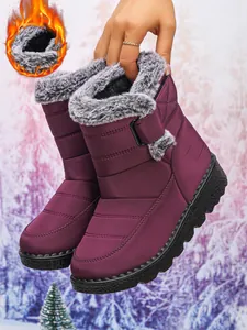Detail view of warm purple waterproof snow boots for women with plush faux fur lining.