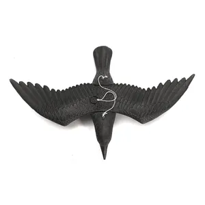 Detailed top view of a realistic black flying crow decoy for outdoor garden decor