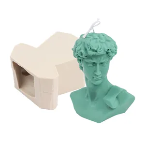 Macro detail showing a green David bust candle beside its professional silicone DIY mold