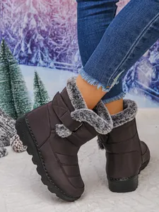 Warm women's snow boots with grey faux fur lining and waterproof exterior shown on model