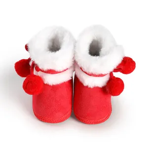 Red fleece-lined winter baby boots featuring white plush fur trim and cute red pom-poms