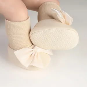 Close-up of baby anti-slip floor socks with large bow and silicone grip dots