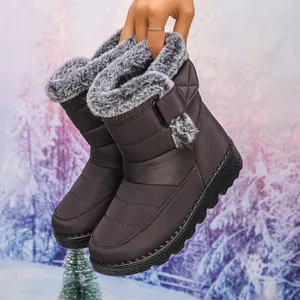 Detailed view of dark brown waterproof snow boots featuring soft grey faux fur trim