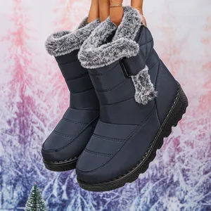 Close-up showing the plush faux fur lining and quilted waterproof fabric of the navy boots.