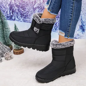 Detailed view of black women's winter snow boots featuring grey faux fur lining.
