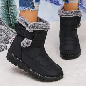 Close-up detail of black waterproof snow boots with fur lining worn in snowy winter scene