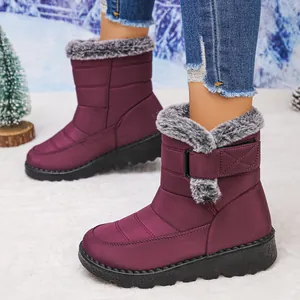 Detail of purple waterproof snow boots featuring plush faux fur lining and velcro strap.