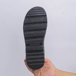 Close-up view of a durable black snow boot rubber sole showing non-slip tread patterns