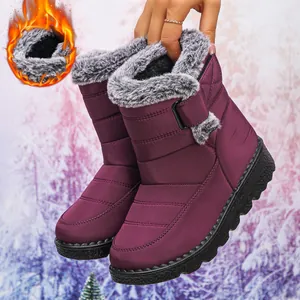 Macro view of women's purple waterproof snow boots with warm grey faux fur lining
