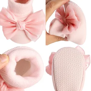 Detail view of pink winter baby shoes with satin bow, fleece lining and anti-slip sole.