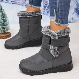 Detail view of women's warm waterproof snow boots with grey fur and velcro strap