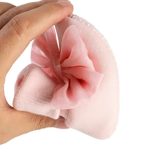 Close-up showing the soft and flexible material of pink baby bow shoes