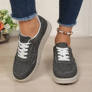 Detailopname van stijlvolle grijze denim dames sneakers met een comfortabele zachte zool