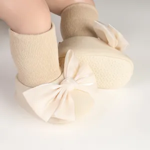 Detailed view of warm winter baby girl fleece-lined shoes with decorative satin bow