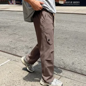Close-up of brown heavy-weight street style cargo pants for men walking on a street
