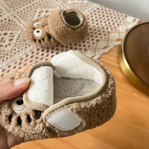 Close-up detail showing soft white plush lining inside warm brown winter baby pre-walker shoes