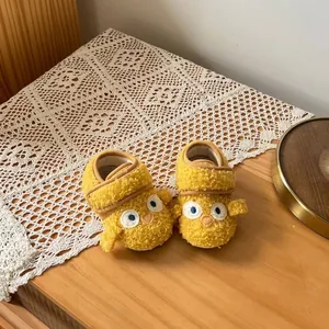 Cozy yellow fleece baby shoes with cute chick design on lace runner