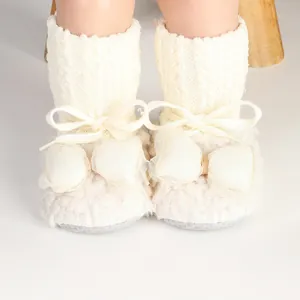 White fleece winter baby shoes with cute bow and ribbon details